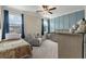 Comfortable bedroom with a blue accent wall, cozy reading chair, and a crib at 1502 Checker Ct, Mount Pleasant, SC 29466