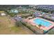 Aerial view of a community pool with a bath house, kiddie area, and playground surrounded by tropical landscaping at 1502 Checker Ct, Mount Pleasant, SC 29466