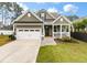 Charming home featuring a welcoming front porch, well-manicured lawn, and two-car garage at 1502 Checker Ct, Mount Pleasant, SC 29466