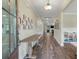 Inviting hallway with wood floors, decorative artwork, and a view of the open-concept living area at 1502 Checker Ct, Mount Pleasant, SC 29466