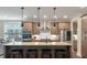 A kitchen island has a stainless steel hood, wooden cabinets, and granite countertops at 1502 Checker Ct, Mount Pleasant, SC 29466