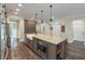 Spacious kitchen island boasts granite countertops, a microwave, and dark wood cabinets at 1502 Checker Ct, Mount Pleasant, SC 29466