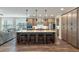An open-concept kitchen features an island with seating and stainless steel appliances at 1502 Checker Ct, Mount Pleasant, SC 29466