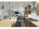 Modern kitchen with a farmhouse sink, granite countertops, and stainless steel appliances overlooking living area at 1502 Checker Ct, Mount Pleasant, SC 29466
