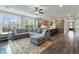 Bright living space with a large sectional couch, an open kitchen, and large windows for natural light at 1502 Checker Ct, Mount Pleasant, SC 29466