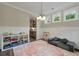 A brightly lit playroom with a large, colorful rug and a view of the outdoors at 1502 Checker Ct, Mount Pleasant, SC 29466
