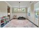 A large, naturally lit play area with a vibrant rug and seating at 1502 Checker Ct, Mount Pleasant, SC 29466