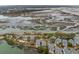 Scenic aerial view of waterfront homes, a private pool, and winding marsh waterways showcasing the coastal lifestyle at 1607 Folly Creek Way Way # C-5, Charleston, SC 29412
