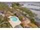 Aerial view of a community with a pool and scenic waterway, offering a blend of relaxation and natural beauty at 1607 Folly Creek Way Way # C-5, Charleston, SC 29412