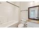 Well-lit bathroom features a shower-tub combo, toilet, and granite-topped vanity with sink and framed mirror at 1607 Folly Creek Way Way # C-5, Charleston, SC 29412