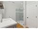 Modern bathroom with glass enclosed shower, white counter tops, and gray cabinetry at 1607 Folly Creek Way Way # C-5, Charleston, SC 29412