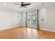 Bright bedroom boasts hardwood floors, ceiling fan, and sliding doors to a private covered porch at 1607 Folly Creek Way Way # C-5, Charleston, SC 29412
