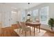 Dining area with hardwood floors, large windows, and modern hanging light fixture at 1607 Folly Creek Way Way # C-5, Charleston, SC 29412