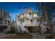 Elegant multi-story coastal home featuring spacious porches, beautiful architectural details, and elevated construction at 1607 Folly Creek Way Way # C-5, Charleston, SC 29412