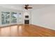 Bright living room featuring a fireplace, hardwood floors, and access to a covered balcony at 1607 Folly Creek Way Way # C-5, Charleston, SC 29412