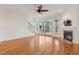 Open-concept living area with hardwood floors, a fireplace, and access to an outdoor balcony at 1607 Folly Creek Way Way # C-5, Charleston, SC 29412