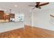 Open concept living room with hardwood floors, flowing into the kitchen and a staircase to the upper level at 1607 Folly Creek Way Way # C-5, Charleston, SC 29412