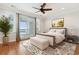 This main bedroom features a ceiling fan, private balcony access, a large area rug, and natural light at 1607 Folly Creek Way Way # C-5, Charleston, SC 29412