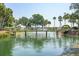 Scenic pond with fountain and wooden bridge, surrounded by lush landscaping and mature trees at 1607 Folly Creek Way Way # C-5, Charleston, SC 29412