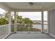 Covered porch showing white railings and columns with a view of the water at 1607 Folly Creek Way Way # C-5, Charleston, SC 29412