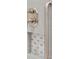 Close up detail of tiled shower with integrated shelf and grab bar at 1607 Folly Creek Way Way # C-5, Charleston, SC 29412