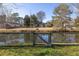 Backyard with a pond view, surrounded by trees and a fence at 1649 Lauda Dr, Mount Pleasant, SC 29464
