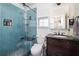 Bathroom featuring a blue tiled shower with a glass door, a sleek toilet, and a modern vanity at 1649 Lauda Dr, Mount Pleasant, SC 29464
