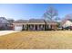 Charming brick home with a covered front porch, white picket fence, and well-manicured landscaping at 1649 Lauda Dr, Mount Pleasant, SC 29464
