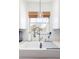 Bright kitchen featuring a large farmhouse sink, modern faucet, and a window view at 1649 Lauda Dr, Mount Pleasant, SC 29464