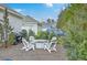 Relaxing backyard space with Adirondack chairs and privacy landscaping at 1702 Sparkleberry Ln, Johns Island, SC 29455