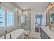 Bright bathroom featuring a freestanding tub, glass-enclosed shower, and serene decor at 1702 Sparkleberry Ln, Johns Island, SC 29455