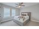 Calm bedroom featuring a plush bed, shuttered windows, and a modern ceiling fan at 1702 Sparkleberry Ln, Johns Island, SC 29455