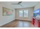Cozy bedroom with hardwood floors, shuttered windows, and a modern ceiling fan at 1702 Sparkleberry Ln, Johns Island, SC 29455