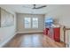 Bright bonus room featuring hardwood floors, stylish decor, and a modern ceiling fan at 1702 Sparkleberry Ln, Johns Island, SC 29455
