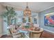 Bright dining area with a modern light fixture, comfortable seating, and easy access to the living room at 1702 Sparkleberry Ln, Johns Island, SC 29455