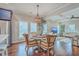 Cozy dining area showcases a stylish chandelier, comfortable seating, and a seamless flow into the living area at 1702 Sparkleberry Ln, Johns Island, SC 29455
