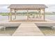 Dock and Lake view with shelter and seating for enjoying the outdoors at 1702 Sparkleberry Ln, Johns Island, SC 29455