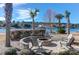 Community fire pit with stone surround and seating area near the water at 1702 Sparkleberry Ln, Johns Island, SC 29455