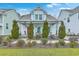 Beautiful two-story home with a meticulously landscaped front yard, a vibrant red door, and light blue window shutters at 1702 Sparkleberry Ln, Johns Island, SC 29455