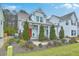 Delightful two-story home with a well-manicured landscape, bright red door, and light blue shutters at 1702 Sparkleberry Ln, Johns Island, SC 29455