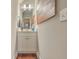 Stylish half bath with hardwood floors, modern vanity, and decorative wall art at 1702 Sparkleberry Ln, Johns Island, SC 29455