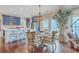 Bright kitchen featuring stainless steel appliances, blue cabinets, white countertops and a wooden dining table at 1702 Sparkleberry Ln, Johns Island, SC 29455