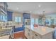 Spacious kitchen featuring stainless steel appliances, blue cabinets, white countertops, an island and hardwood floors at 1702 Sparkleberry Ln, Johns Island, SC 29455