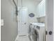 Efficient laundry room featuring white cabinets and modern washer/dryer set at 1702 Sparkleberry Ln, Johns Island, SC 29455