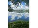 Scenic pond view showcasing reflected sky and nearby community at 1702 Sparkleberry Ln, Johns Island, SC 29455