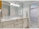 Bathroom featuring double sinks with marble countertop, white cabinetry, and a large mirror at 1886 Omni Blvd, Mount Pleasant, SC 29466