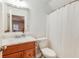 Bathroom featuring a marble countertop, wood cabinet, large mirror, and a shower with a white curtain at 1886 Omni Blvd, Mount Pleasant, SC 29466