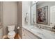Elegant half bathroom with marble countertop and decorative mirror at 1886 Omni Blvd, Mount Pleasant, SC 29466
