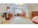 A large, colorful bedroom features a big fluffy rug, window with plantation shutters, and a desk with a chair at 1886 Omni Blvd, Mount Pleasant, SC 29466