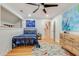 A bedroom with a black bedframe, a patterned rug, light blue walls, and a wooden dresser at 1886 Omni Blvd, Mount Pleasant, SC 29466